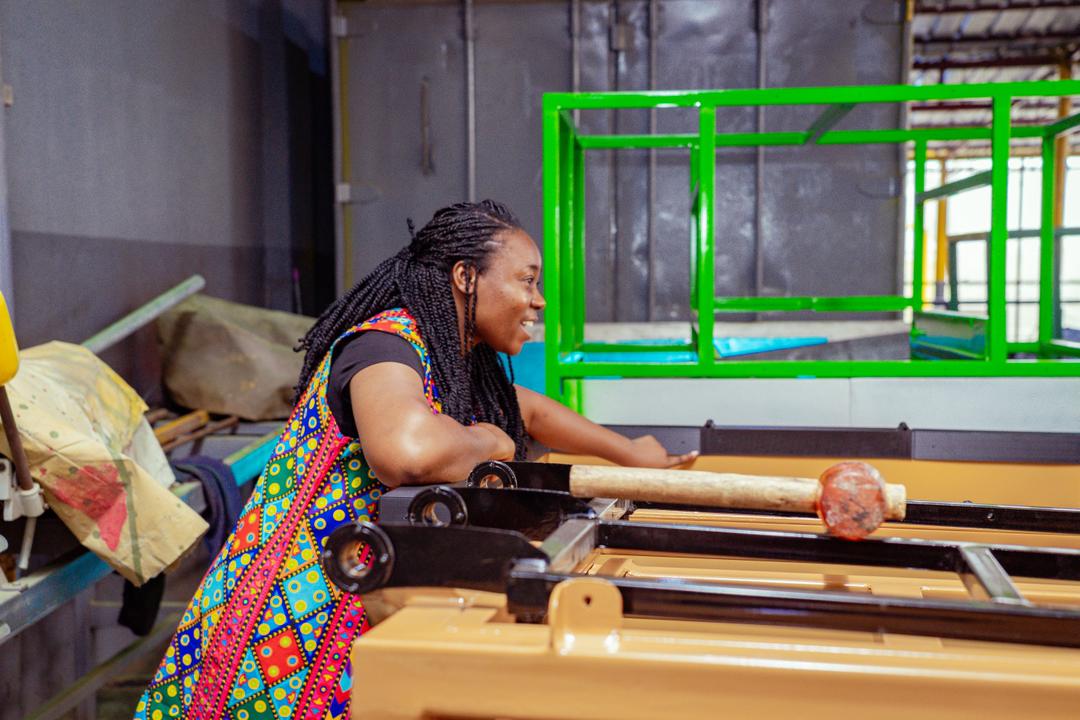 Blessing Ekwere working beside the NaturePacks production equipment