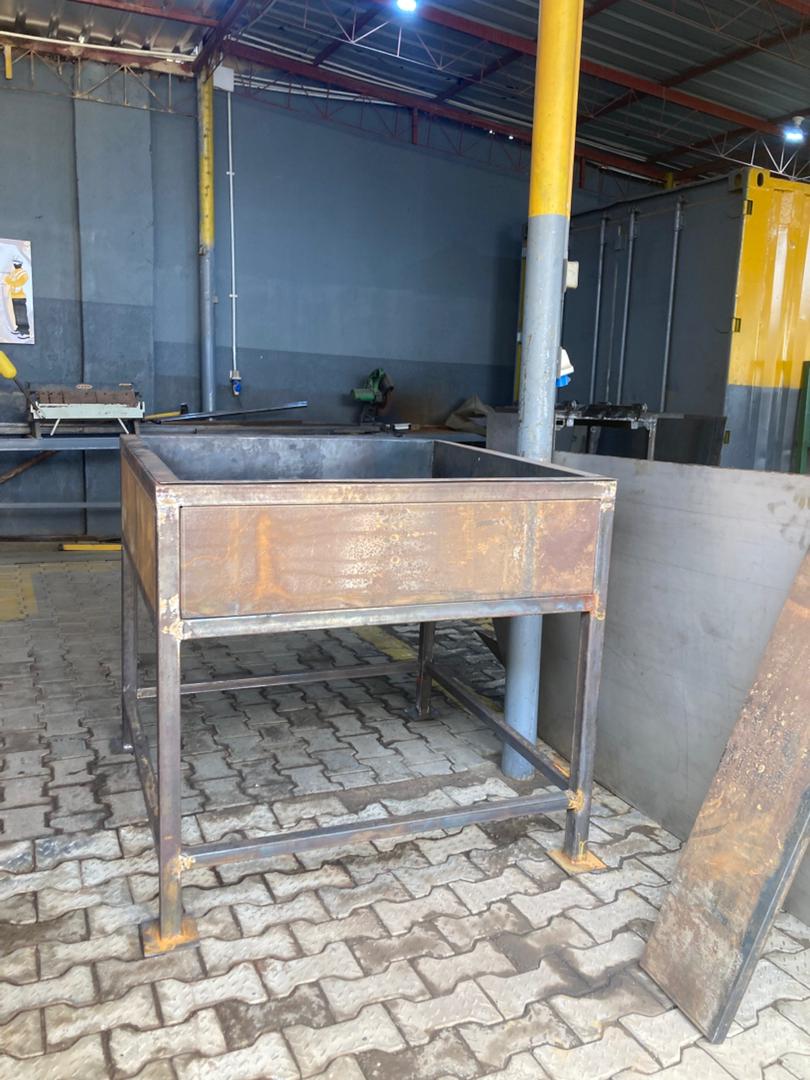 Custom-fabricated metal pulping basin chassis being built at the fabrication workshop